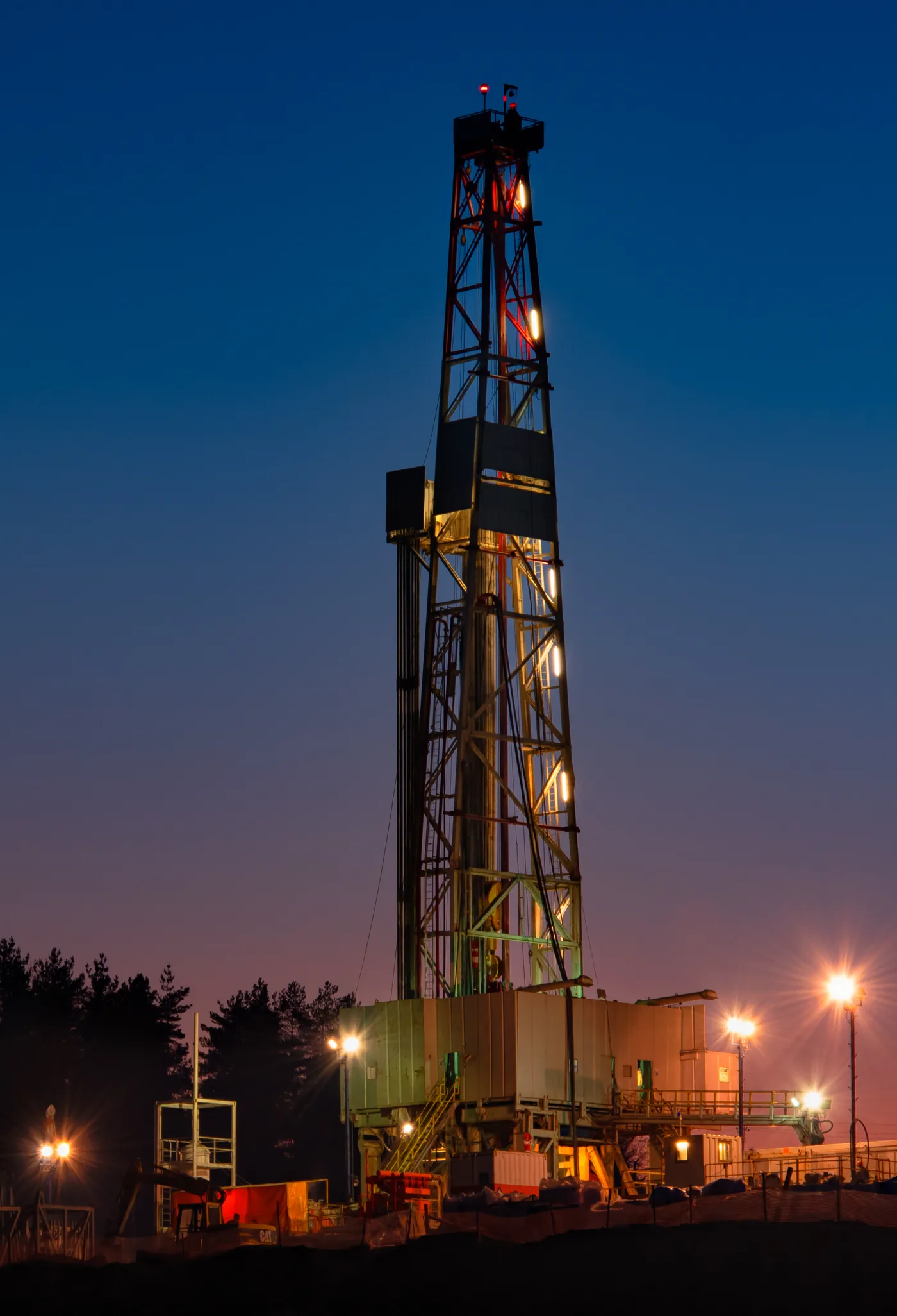 A drilling rig lit at night