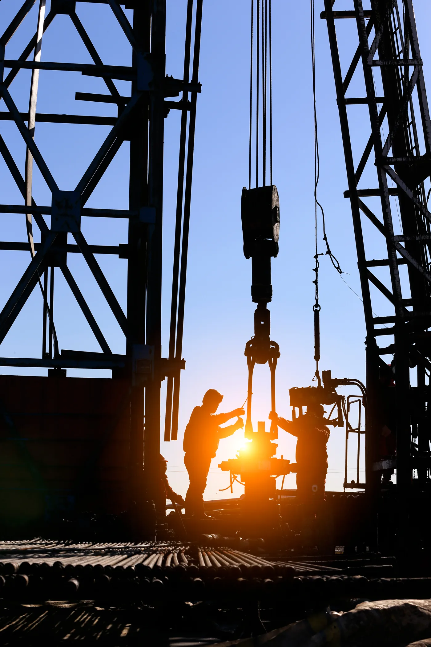 Crew working on a rig at sunset