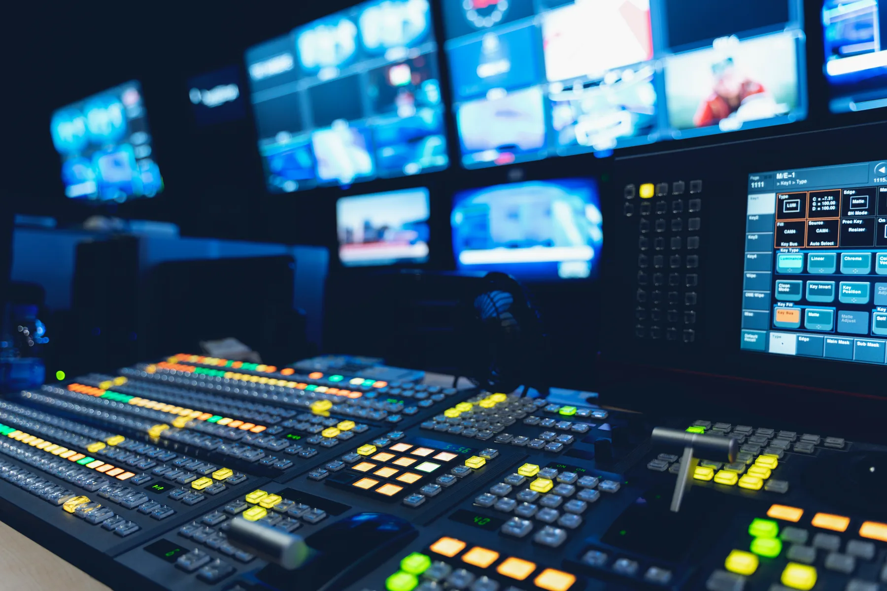 A broadcast control room with a switcher and monitors