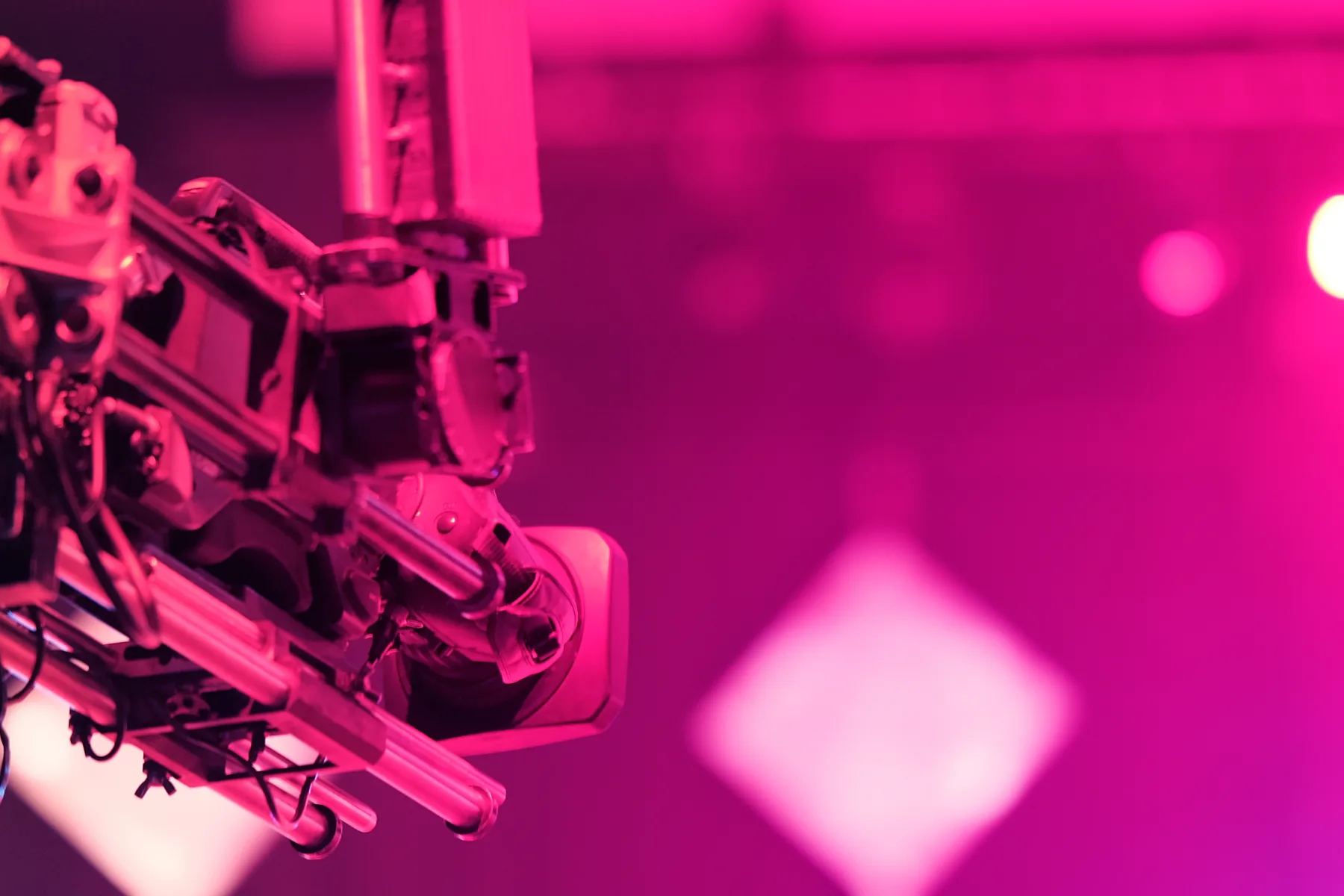 A camera crane over a lit stage