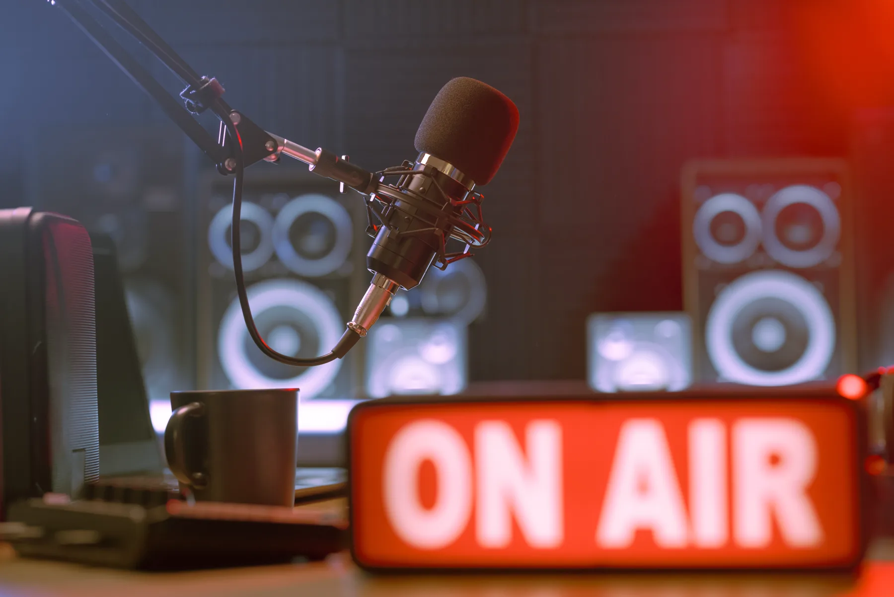 A studio microphone beside an on-air light