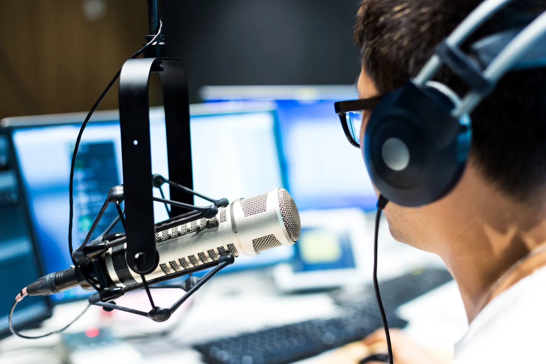 A presenter at a studio microphone
